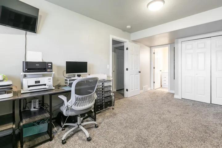 Soft gray carpeting, light gray wall paint, and white trim accents