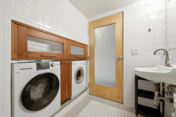 White subway tile walls and mosaic tile flooring