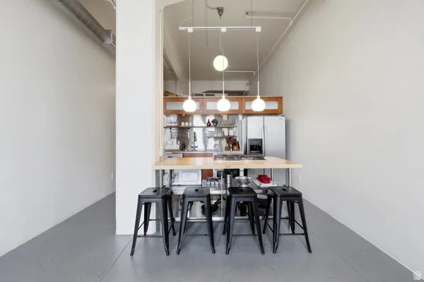 Kitchen featuring stainless steel appliances, wood-finish cabinetry, and a butcher block island