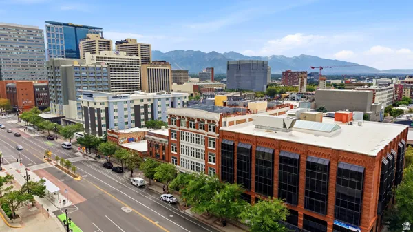 Urban landscape with a prominent commercial building featuring large windows, brick exterior, and a flat roof