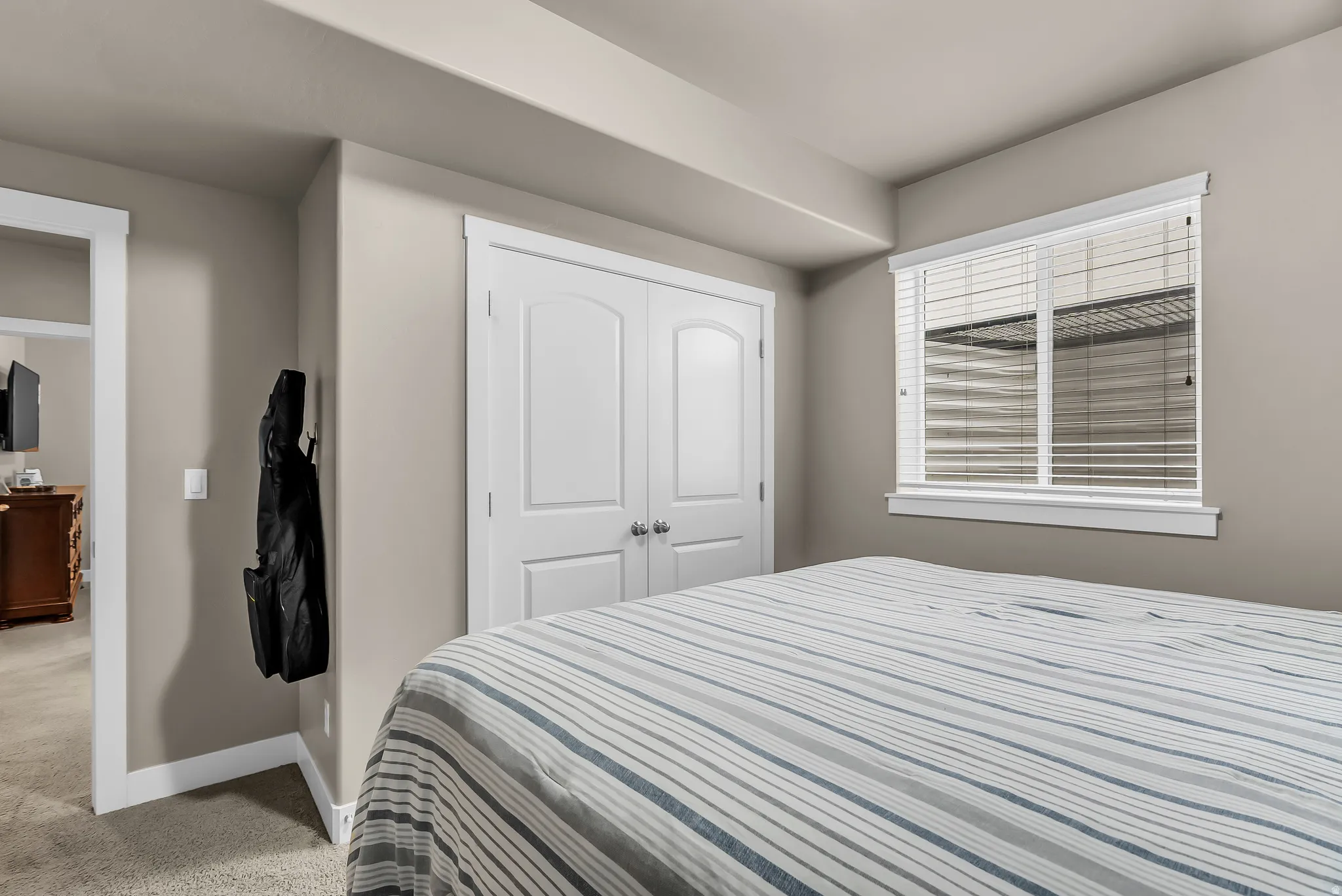 Recessed lighting, plush carpeting, white interior doors, and a window with white blinds