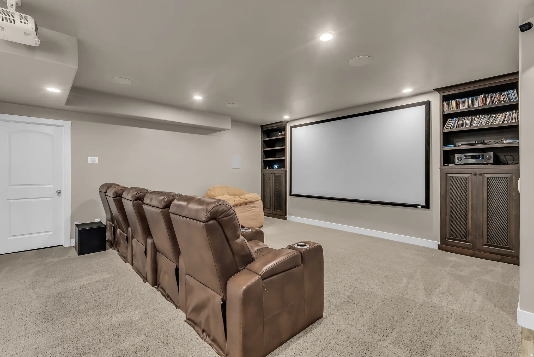 Built-in entertainment center featuring a large projection screen and integrated shelving