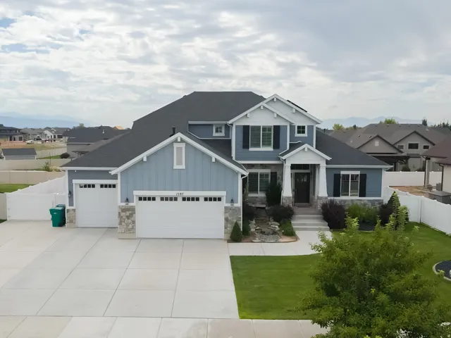 Two-story residence with blue siding and white trim accents