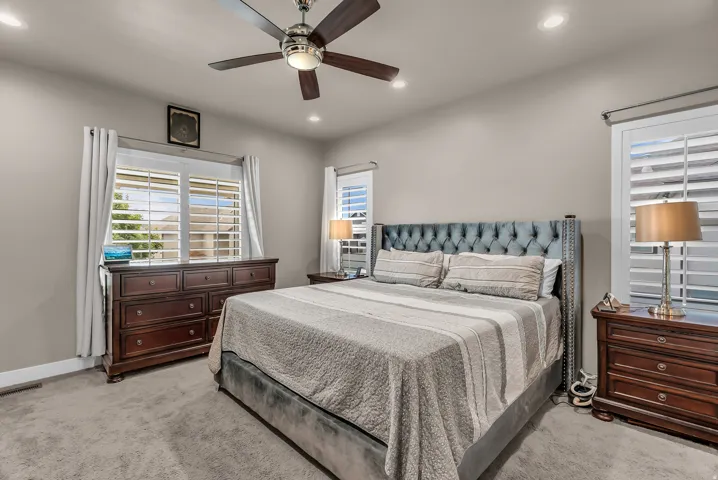 Ceiling fan with integrated lighting, recessed lighting, plantation shutters, and light gray wall paint