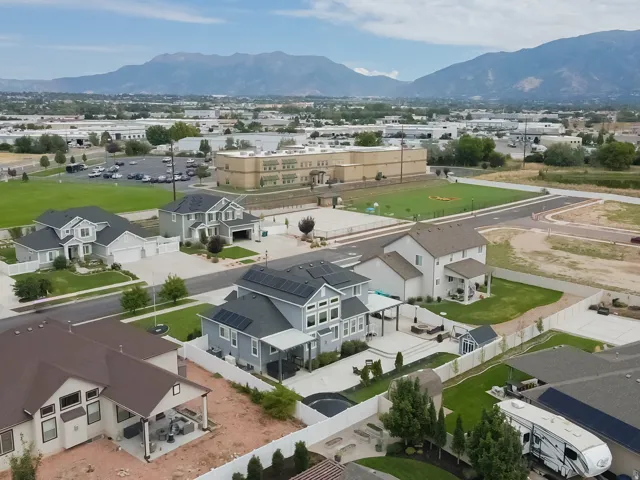 Suburban setting featuring multiple homes with solar panel installations