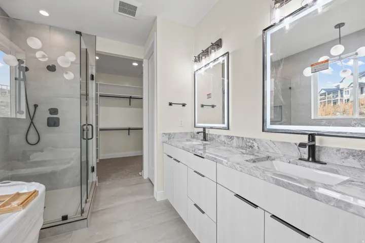 Dual vanity with stone-finish countertops and integrated rectangular sinks