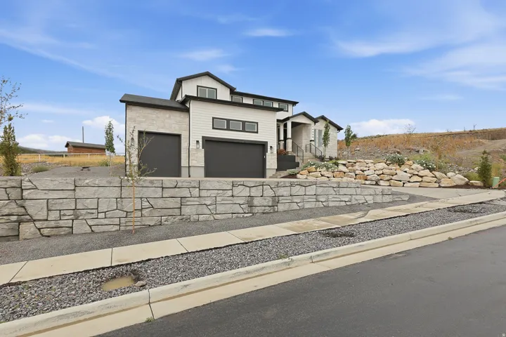 Modern exterior with light-colored stone and white siding
