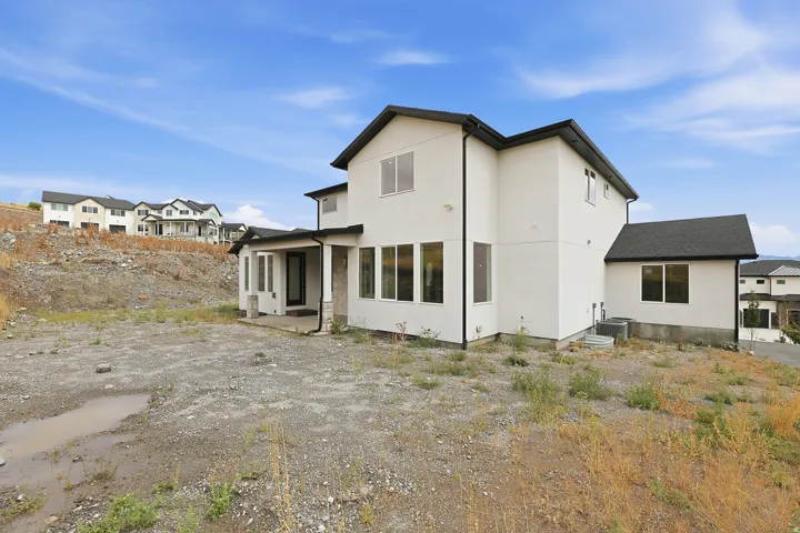Contemporary exterior with white stucco finish and black trim