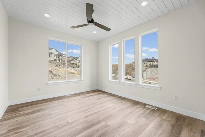Shiplap ceiling with recessed lighting and a ceiling fan