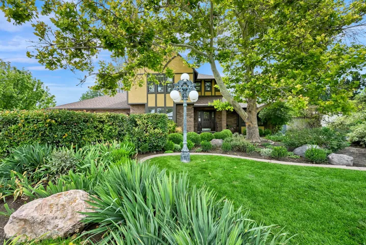 Manicured lawn with mature trees and diverse landscaping