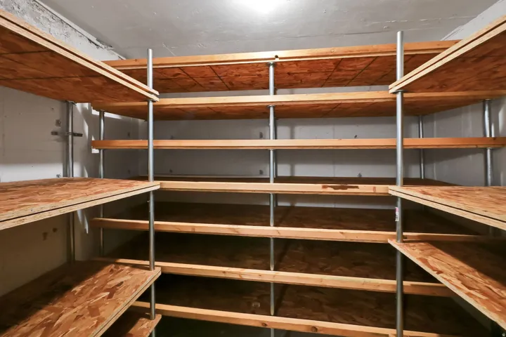 Extensive built-in shelving with wood-finish surfaces and metal supports