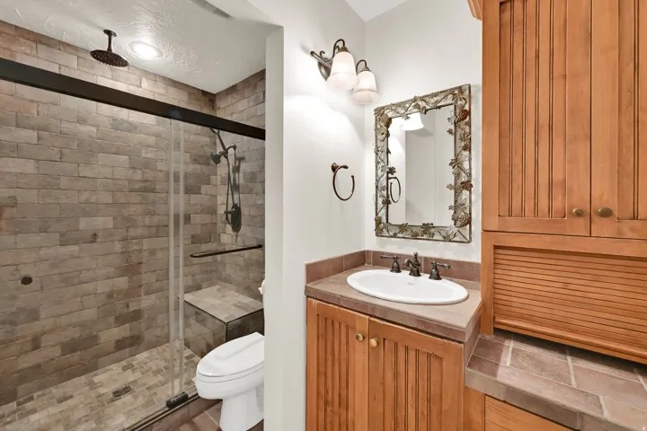 Tiled shower with a built-in bench and glass enclosure