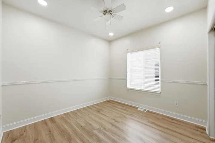 Recessed lighting, ceiling fan, crown molding, wood-finish flooring, and window with blinds