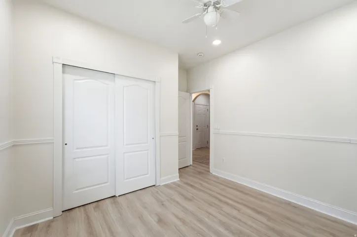 Recessed lighting, ceiling fan, wood-finish flooring, wainscoting, and sliding closet doors