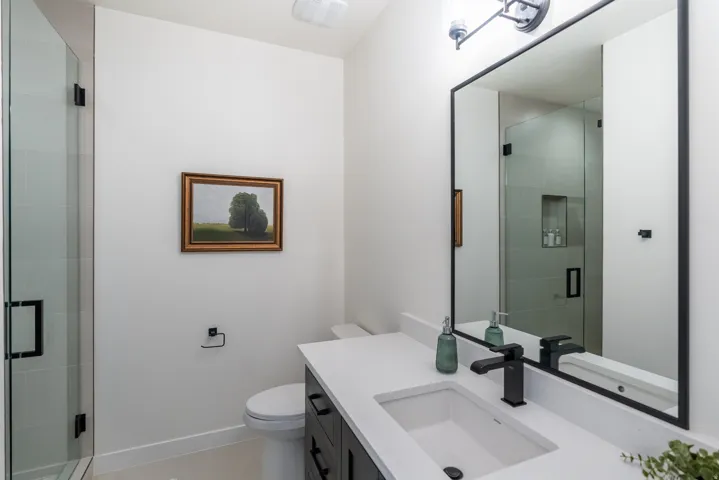 Shower with clear glass enclosure and matte black hardware