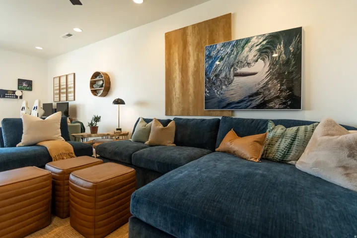 Recessed ceiling lighting, white wall finishes, and a dark ceiling fan
