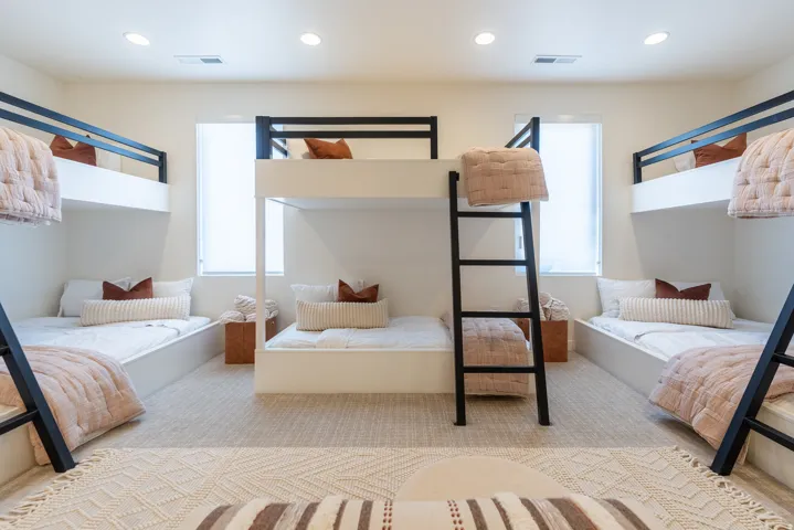 Recessed lighting illuminates this room featuring light-toned carpeting