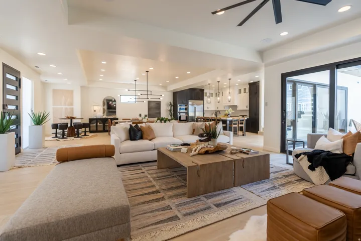 Expansive open-concept living area featuring wood-finish flooring, recessed lighting, and a modern ceiling fan