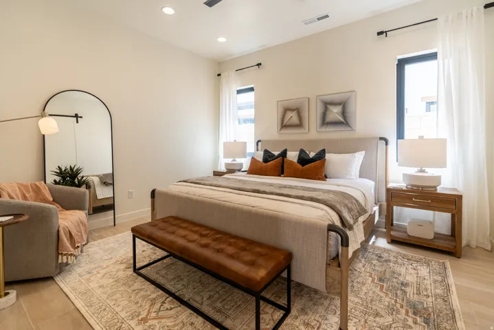 Recessed lighting illuminates the neutral wall tones and wood-finish flooring