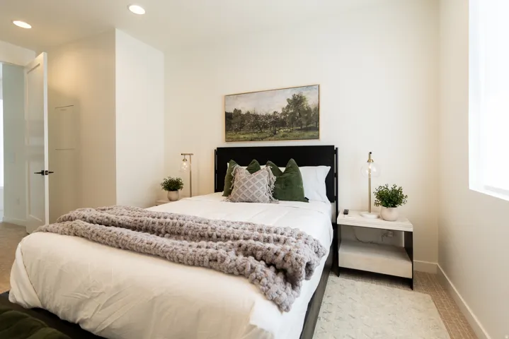 Recessed ceiling lighting, wood-finish flooring, white wall paint, and a built-in wall niche