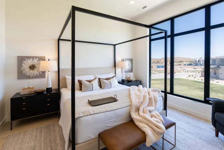 Expansive floor-to-ceiling windows, recessed lighting, and light wood-finish flooring