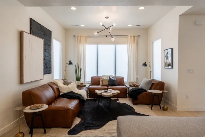Recessed lighting, contemporary chandelier, light wood-finish flooring, and light-colored walls