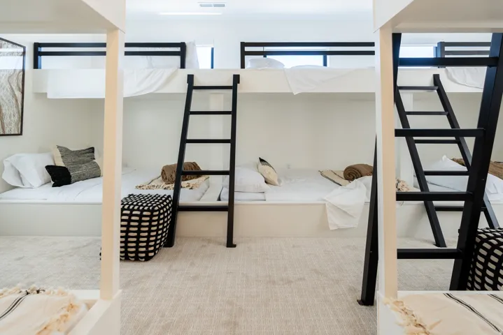 Built-in bunk beds with black metal ladders