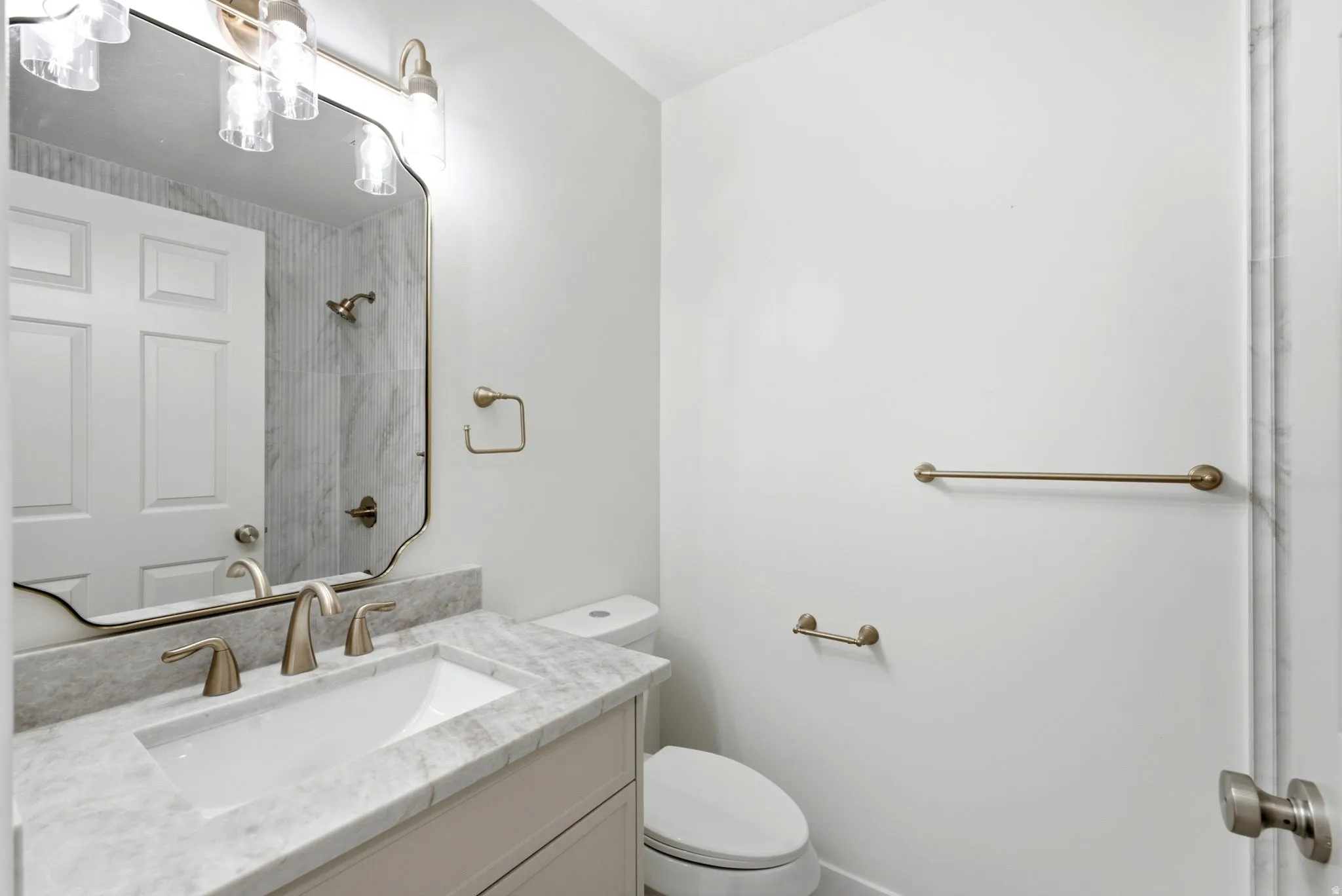 Integrated vanity with white rectangular under-mount sink and marble-finish countertop