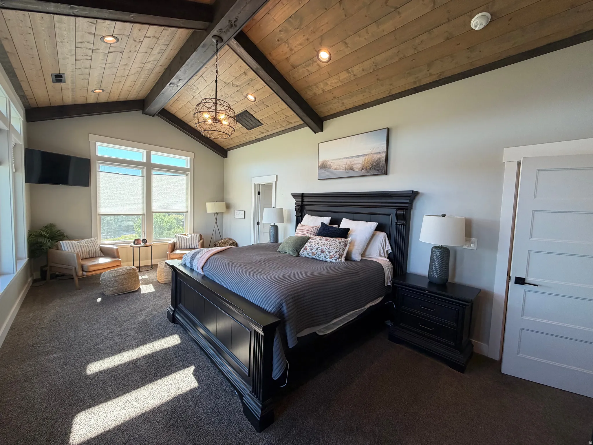 Vaulted ceiling with exposed wood beams and wood-finish paneling