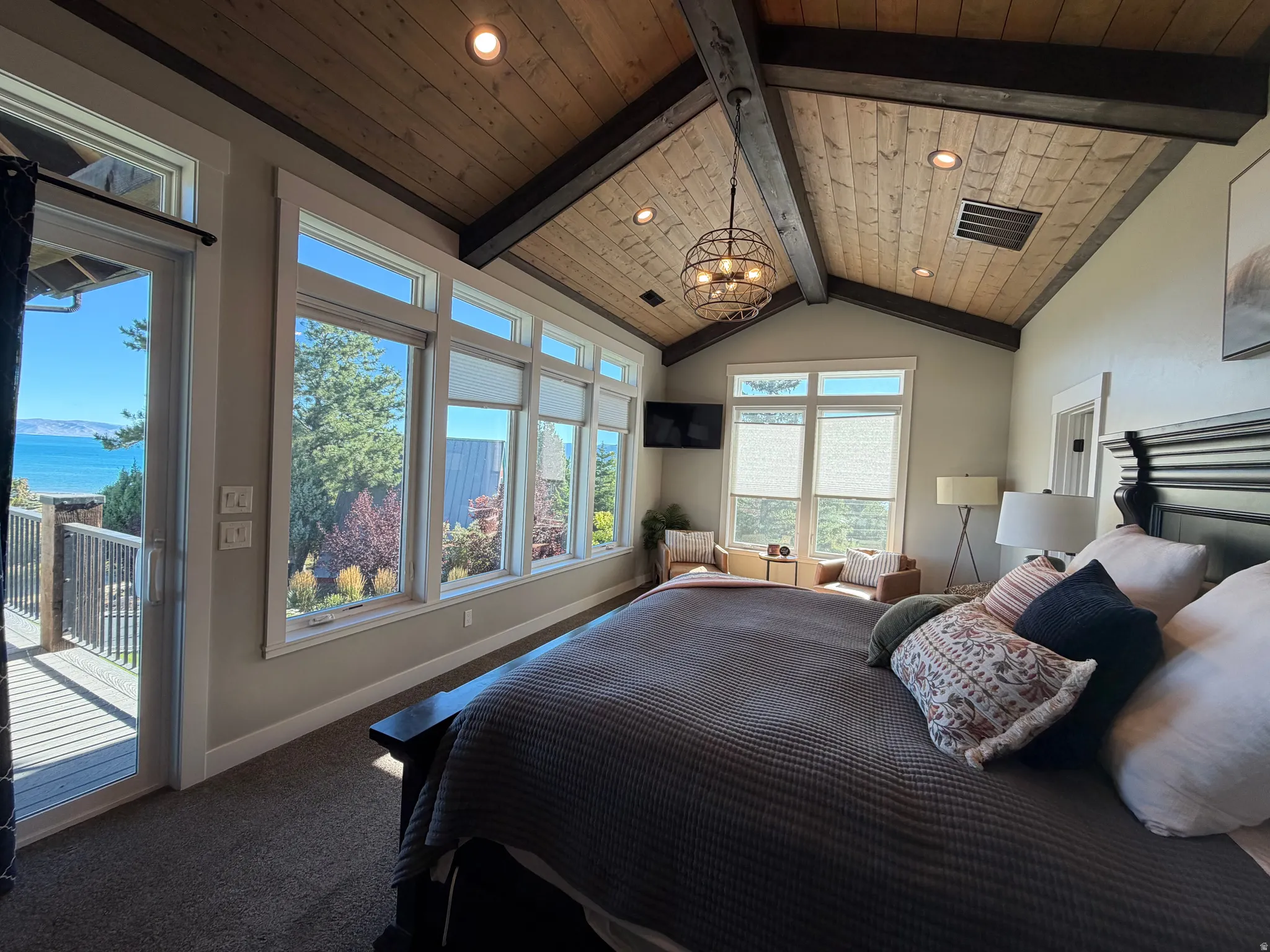 Vaulted wood-finish ceiling with exposed beams and recessed lighting