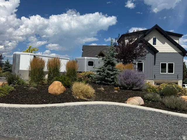 Modern exterior with grey horizontal siding and light-toned upper siding
