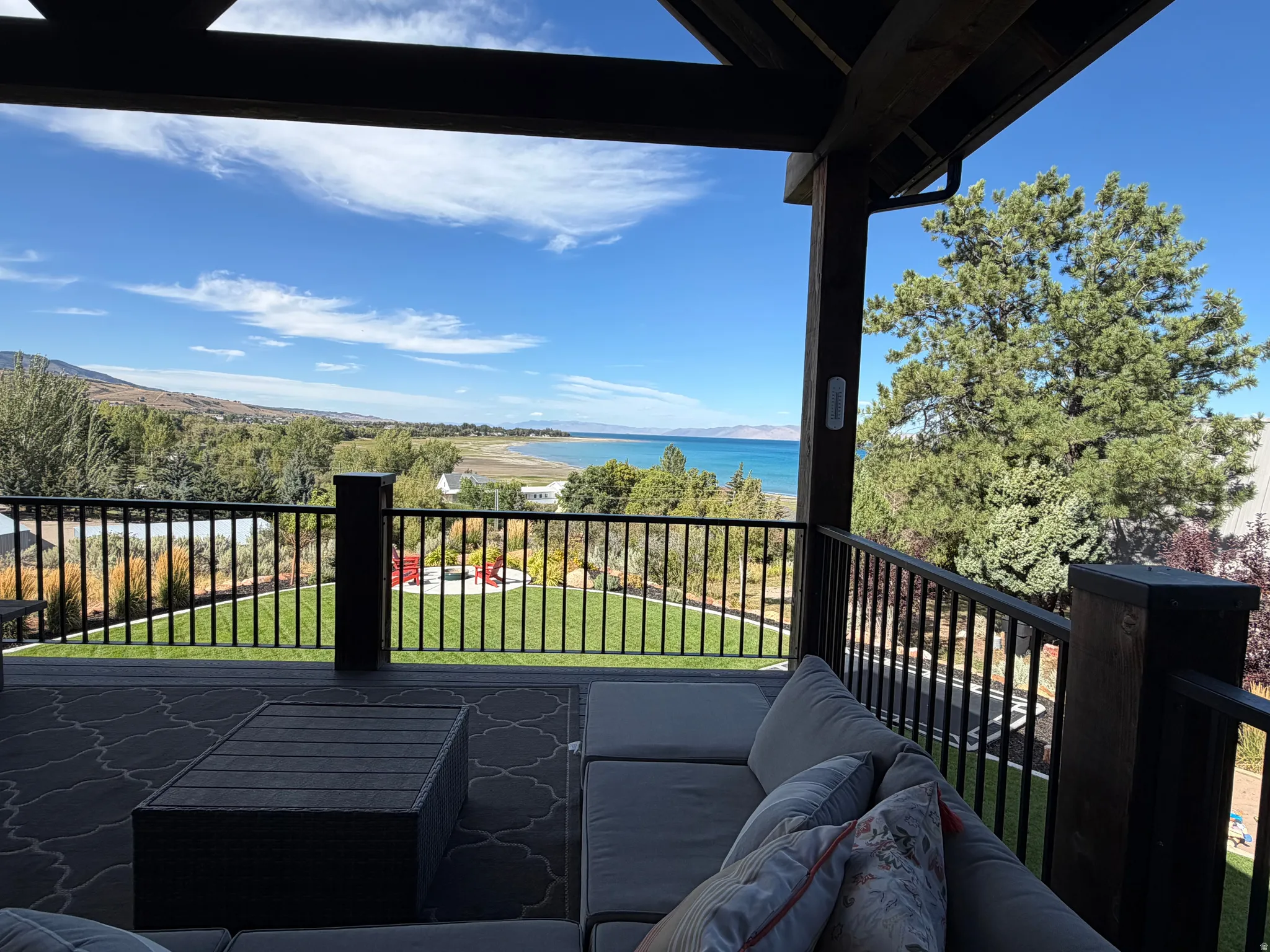 Expansive deck with a durable dark-toned surface and black metal railings