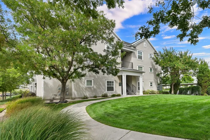 Stucco exterior with white trim windows and columns