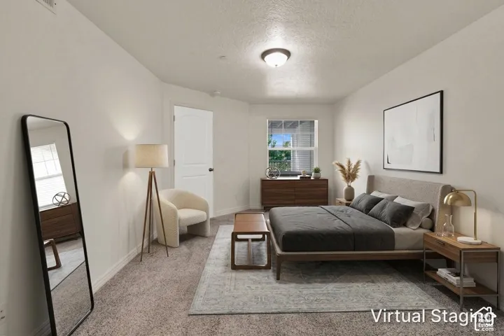 Primary bedroom with new, plush carpet, a window with blinds, and recessed lighting (virtual staging)