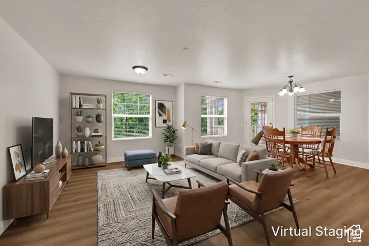 Laminate wood-like flooring, multiple windows with blinds (virtual staging)