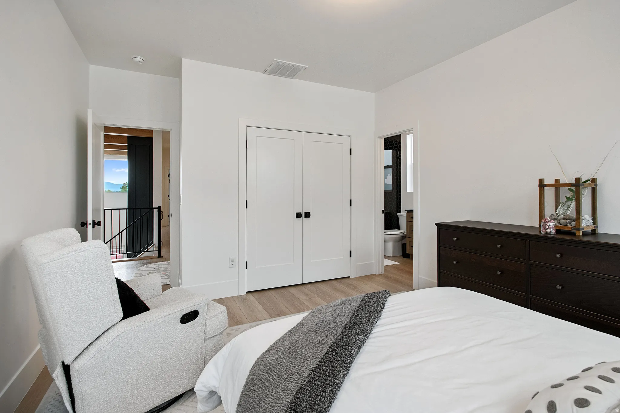 Light wood-finish flooring with white walls and trim
