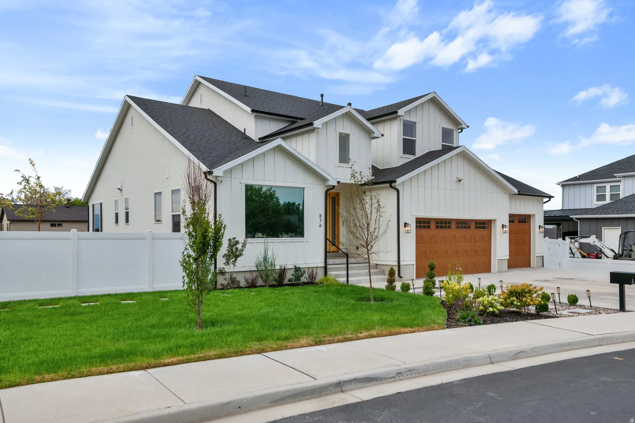 Contemporary two-story exterior with white siding and dark shingle roofing
