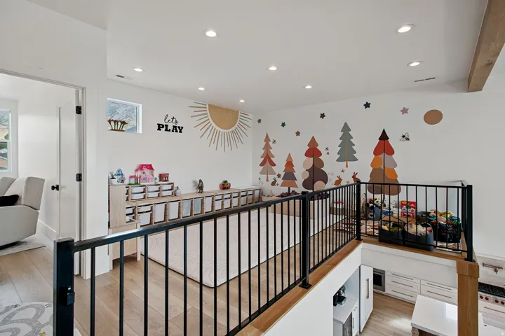 Loft area with recessed lighting, wood-finish flooring, white walls, and black metal railings