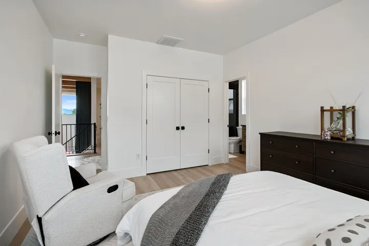 Light wood-finish flooring with white walls and trim