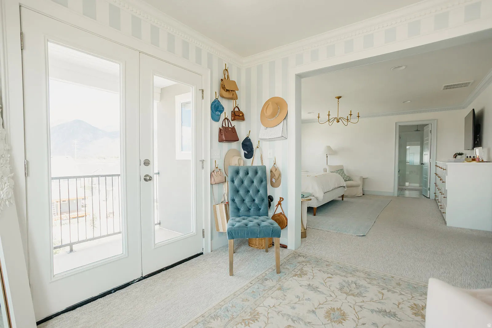 Double French doors with a balcony railing, striped wall paneling, and crown molding