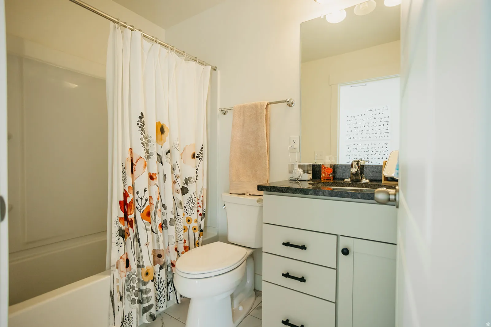 White tub and shower combination with a single handle faucet