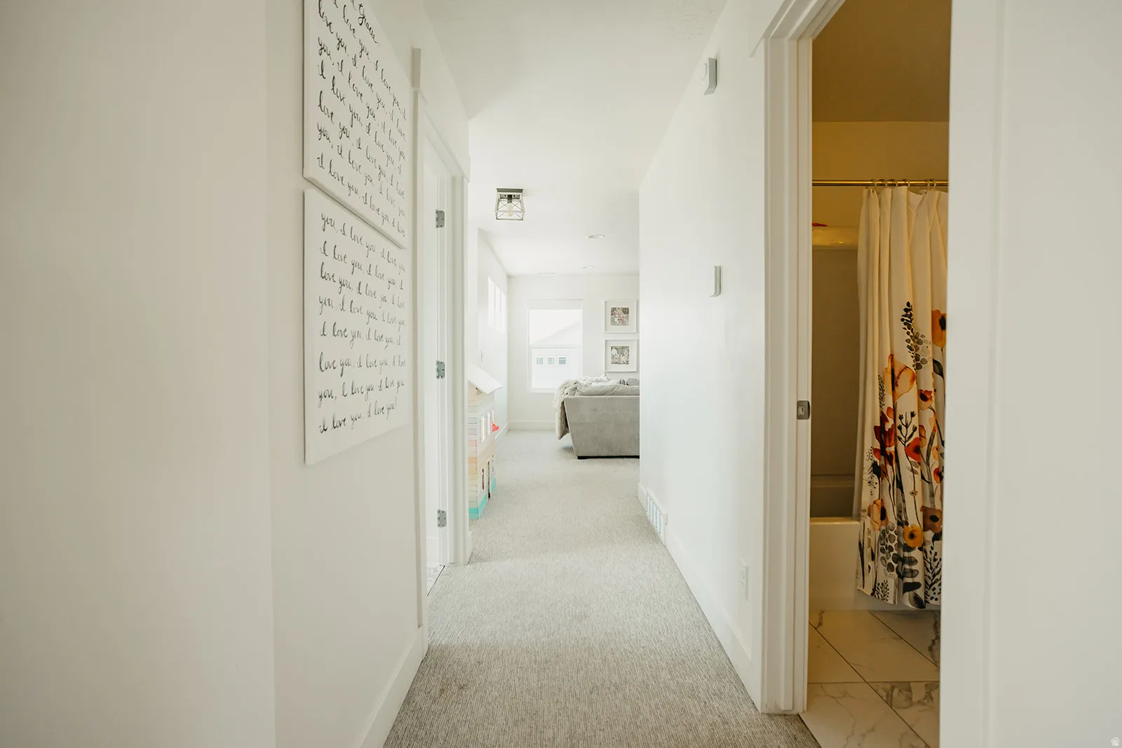 Recessed lighting, light-toned carpeting, and white wall finishes