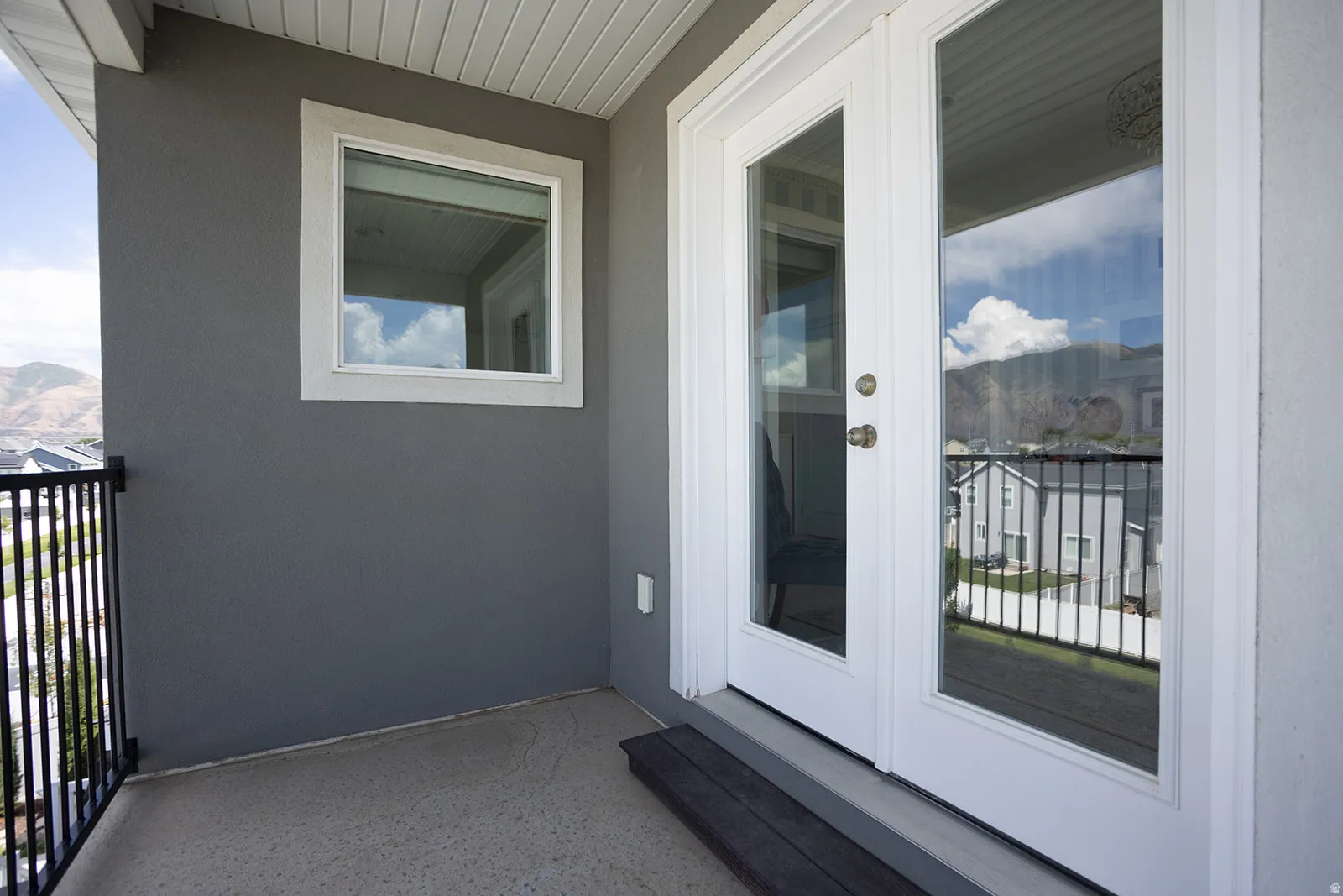 Exterior balcony featuring a concrete surface and black metal railing