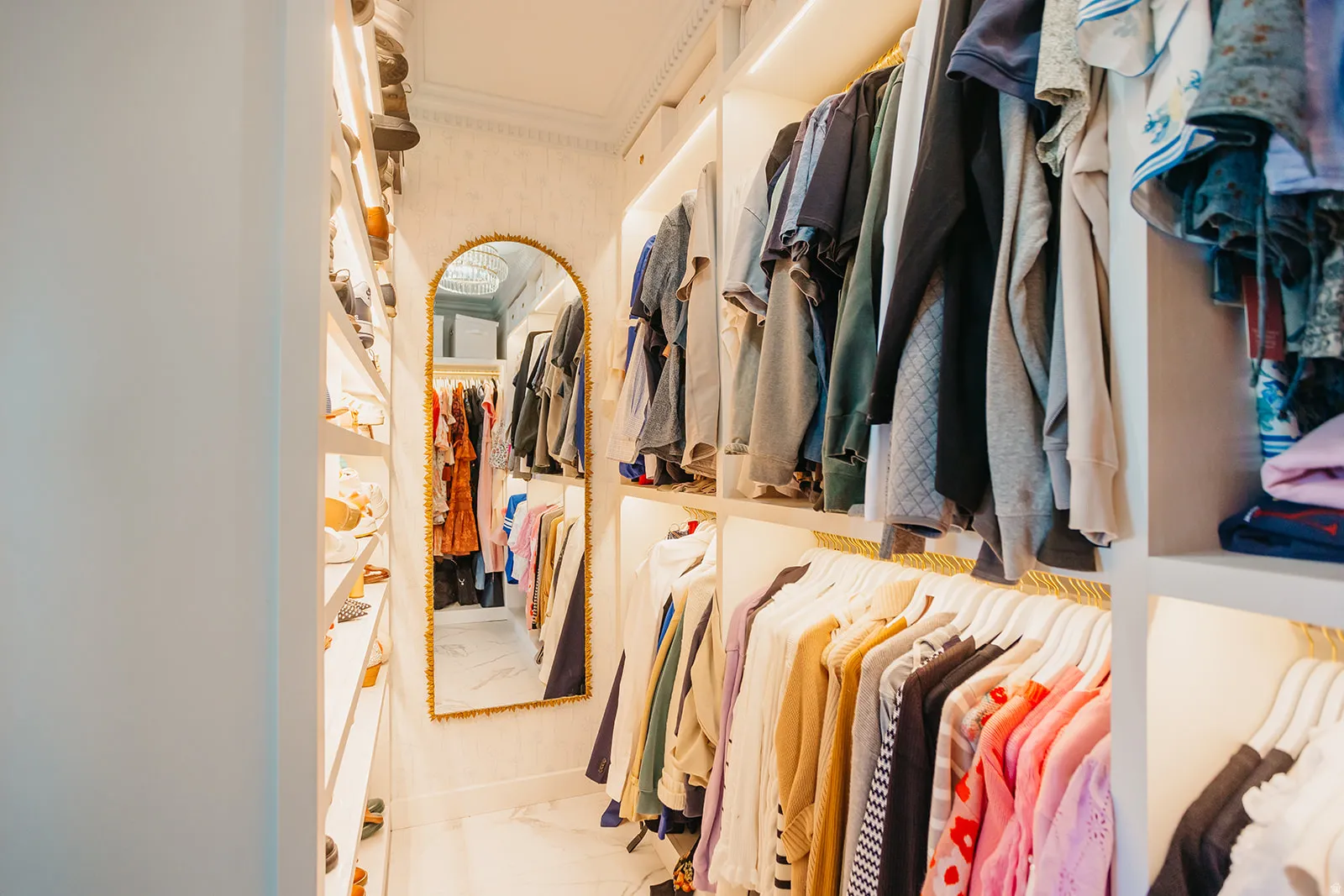 Custom closet system featuring built-in shelving, integrated lighting, and dedicated hanging space