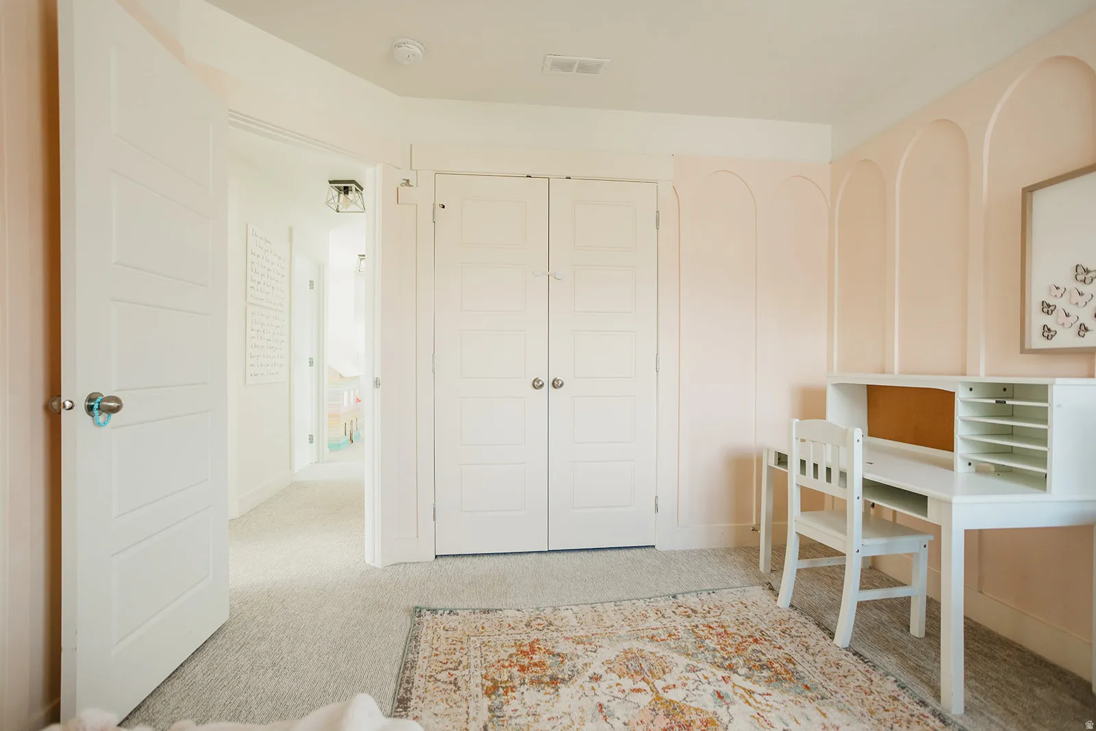 Neutral carpeting and light-toned walls