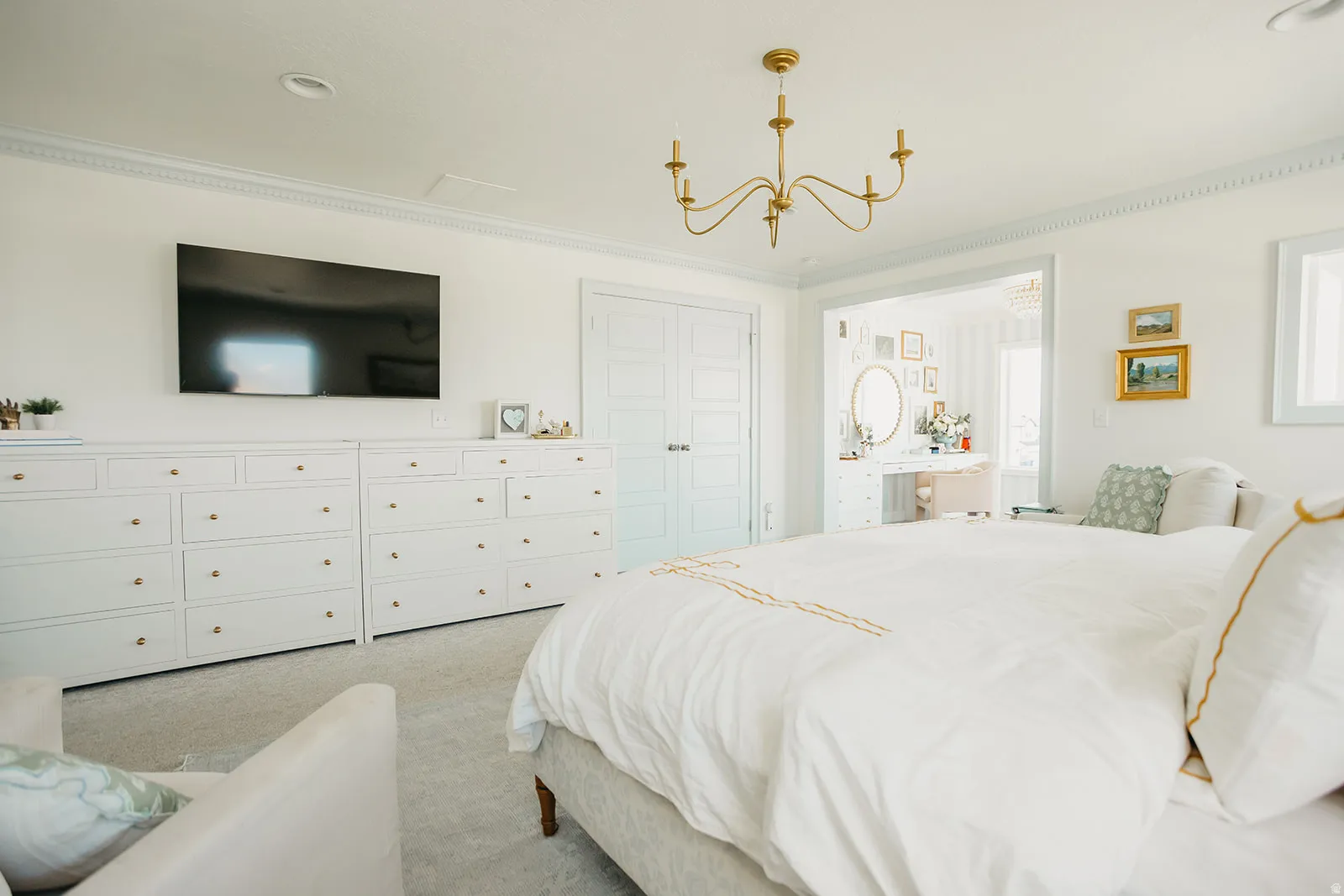 Recessed ceiling lighting, crown molding, double doors, and a gold-finish chandelier