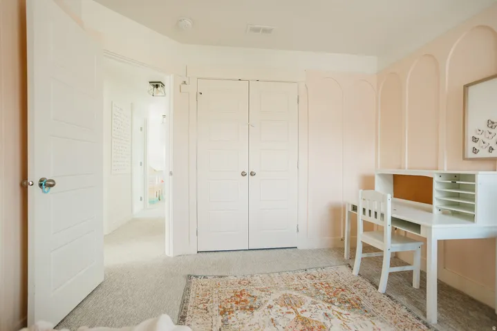 Neutral carpeting and light-toned walls
