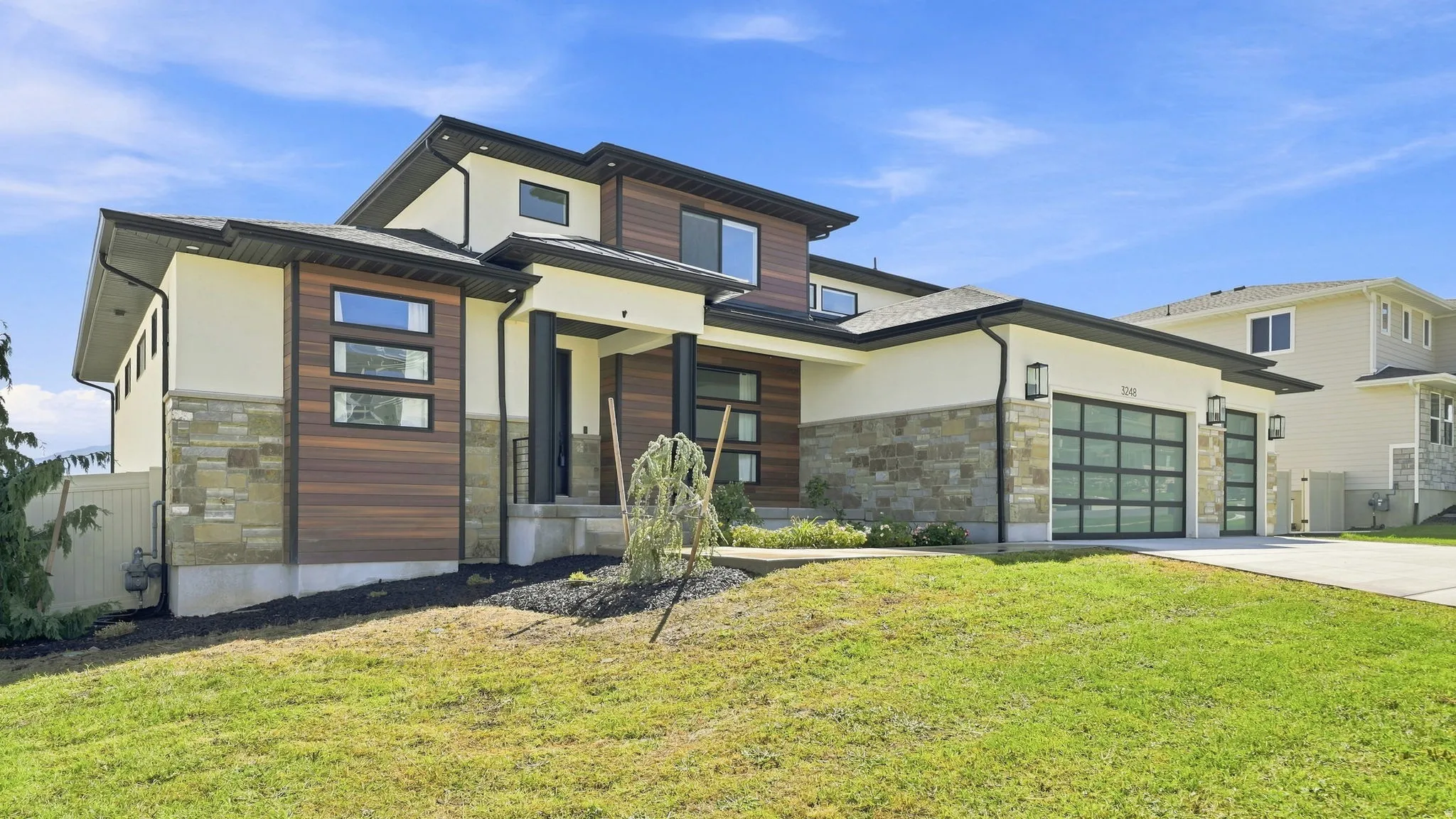 Modern exterior design with stone accents and horizontal wood-finish siding