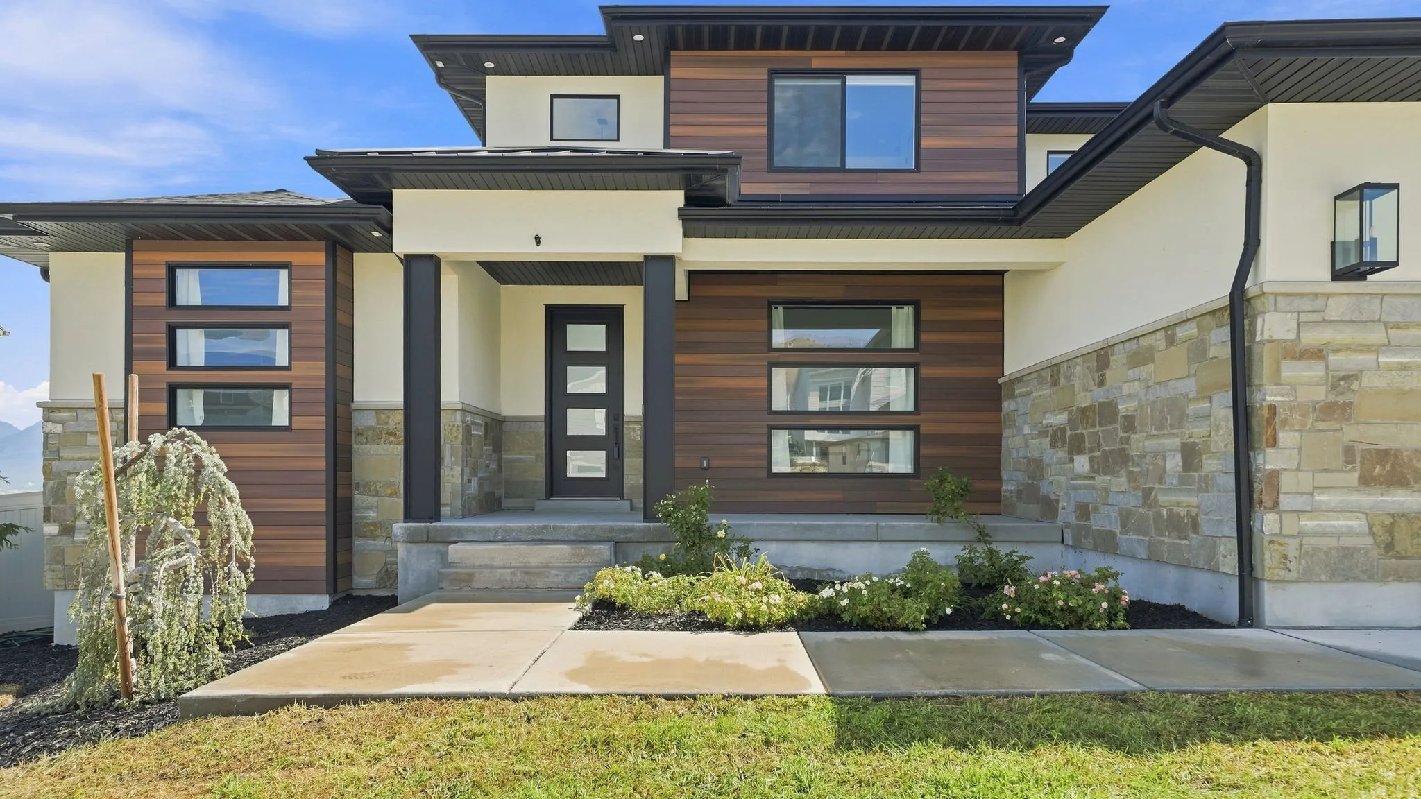 Contemporary exterior with stone veneer and wood-finish siding