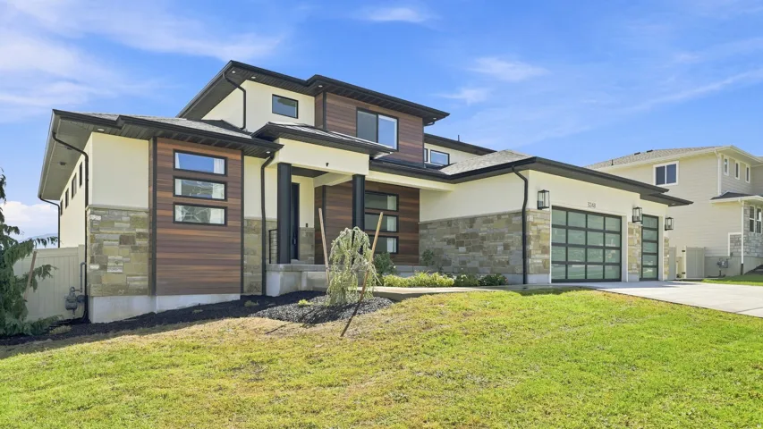 Modern exterior design with stone accents and horizontal wood-finish siding